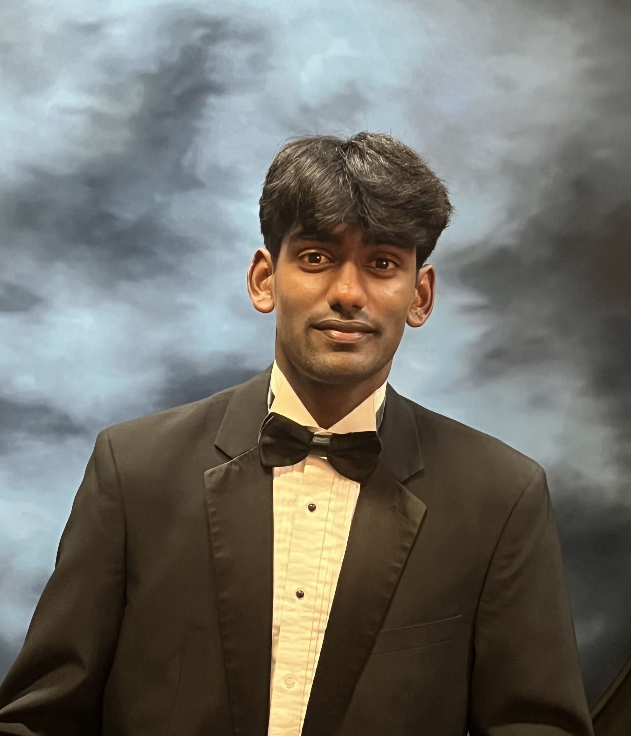 Portrait of Shreev in a black suit and bow tie